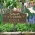 Forever in Our Hearts Memorial Yard Sign in Antique Brass in the Garden Surrounded by Lush Greenery and Colorful Flowers