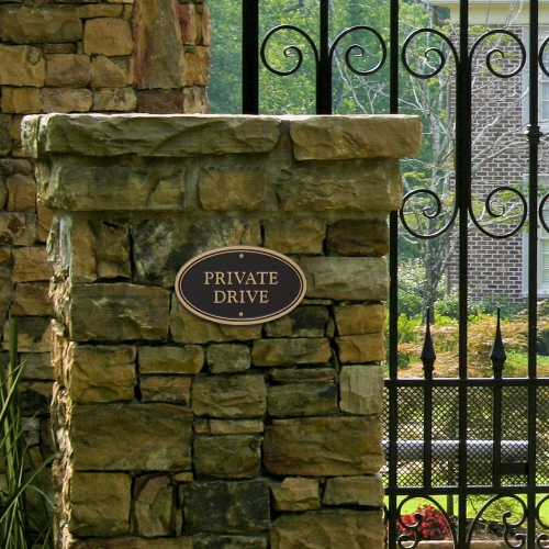 Private Drive Plaque Oval Shape Black & Gold on wall