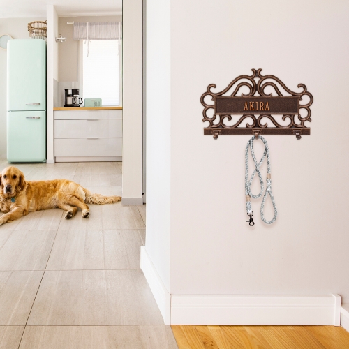 Scroll Style Leash or Key Hook Plaque in Antique Copper Hanging on Wall by Entrance door with Leash on it and Dog  laying in the Kitchen