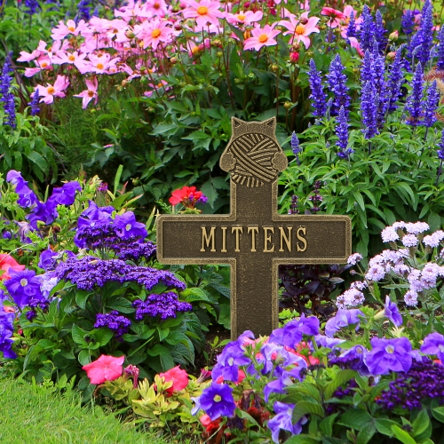 Kitten with Yarn Memorial Lawn Cross Antique Brass  in the Garden Surrounded by Bright Colorful Flowers